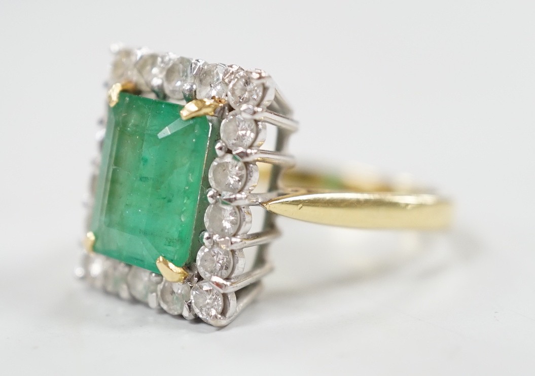 A modern 18ct gold, emerald and diamond set rectangular cluster ring, size Q, gross weight 6.4 grams.